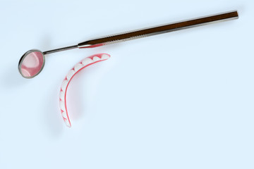 Dental medical tools, dentist equipment: stomatological mirror, false white teeth.