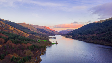Scottish beautiful colorful sunset landscape with Loch Voil, mountains and forest at Loch Lomond & The Trossachs National Park