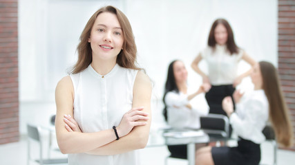 young employee on blurred office background.photo with copy space