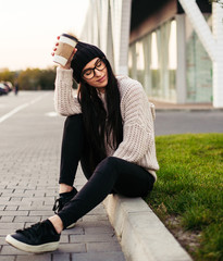 Fototapeta premium young woman drink coffee near shopping mall