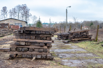 Old wooden railway ties. Renovation and replacement of tracks in the engine house.