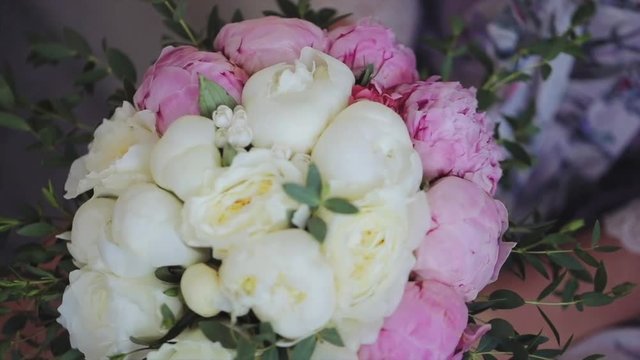 Gentle flowers peonies. Beauty wedding bouquet in bride's hands
