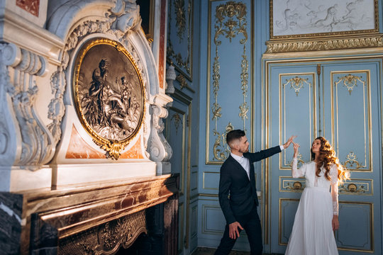 A wonderful and stylish wedding couple charismatically dancing in the classical hall