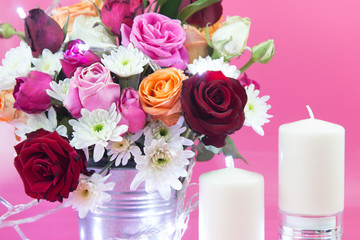 Vase of bouquet Roses and white candlestick lighting bulb and Vase of bouquet Roses. 