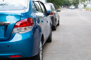 Obraz na płótnie Canvas Close-up of blue car parked in parking lot.