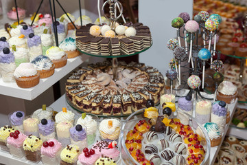 Cake pops and lollipops, colorful cupcakes, confectionery buffet