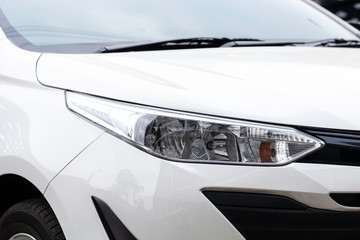 Obraz na płótnie Canvas Closeup of headlight white car.