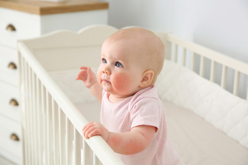 Adorable little baby with allergy in crib at home