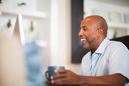 Mature African American Man Working From His Home Office.