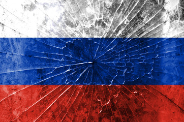 Flag of Russia on the background texture of broken glass in the form of a spider web