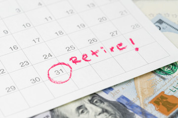White clean calendar with circle at date and handwriting text as Retire on US dollar banknote using...