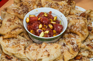 A variety of original pancakes with quince candied fruit and pistachios in the contest during the celebration Russian Shrovetide (pancake week) at school