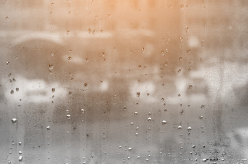 water droplets on glass with blurred boke in background