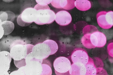 water droplets on glass with blurred boke in background