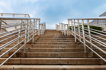 Old stone steps and stainless steel guardrail on the steps