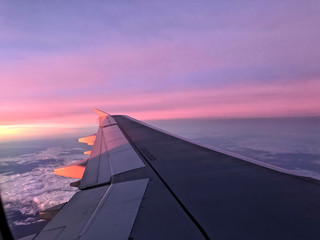 Fototapeta na wymiar airplane wing and pink sunset