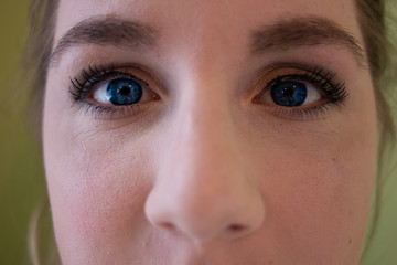 blue eyed women close up photo