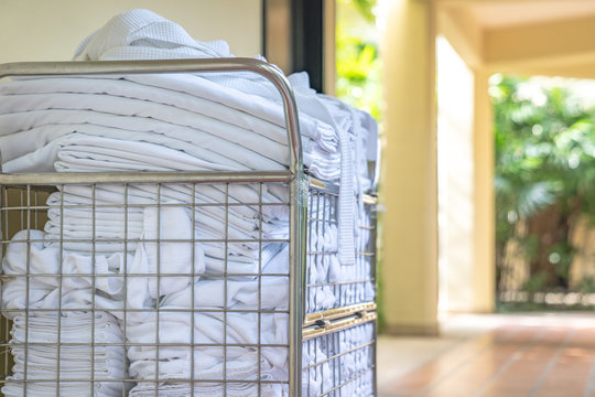 Hotel Maid Trolley Parking Front Of The Room With Clean Towel And Bathrobes Ready To Change And Make Up The Room.