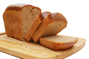 close-up of sliced loaf of rye bread on cutting board isolated on white background