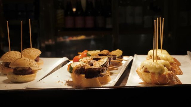 Showcase window display assortiment with tapas &ndash; traditional Spanish sandwiches in a cafe in Barcelona, Spain close up macro