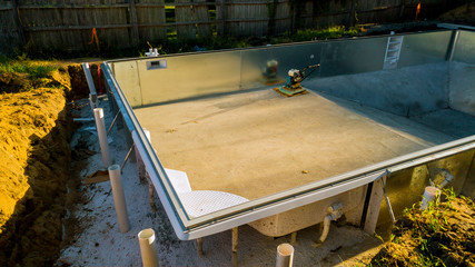 Works for the installation of a swimming pool. Swimming pool under construction.