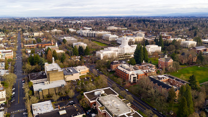 The state capital building adorned with the Oregon Pioneer with Willamette University grounds...