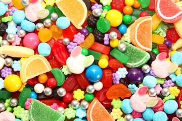 Assorted variety of sweet sugar candies includes, gummy bears, Easter bunny candy, gum balls and...