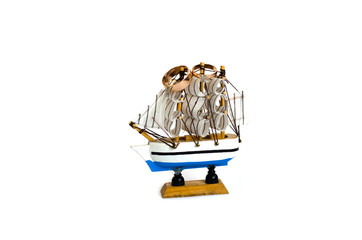 Sailing ship model with wedding rings isolated on white background