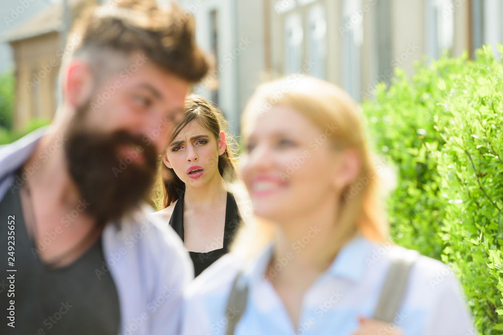 Wall mural Getting her jealous. Romantic couple of man and woman dating. Bearded man cheating his girlfriend with another woman. Unhappy girl feeling jealous. Jealous woman look at couple in love on street