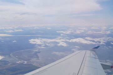 Fototapeta na wymiar the view from the window of the aircraft, the wing of the aircraft against the sky, clouds