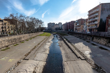 Fototapeta na wymiar Onyar river cityscape in Girona, Catalonia, on a blue sunny sky