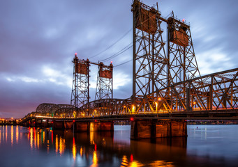 Lifting Columbia Interstate bridge over the Columbia River connecting Oregon and Washington and shines with colorful evening lights
