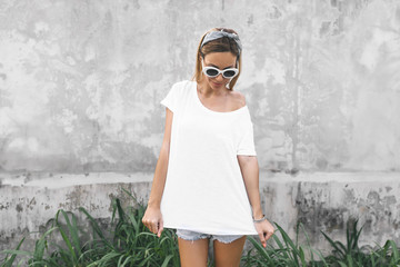 Woman in white t-shirt on grey background