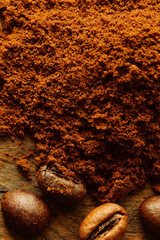  ground coffee and coffee beans  on rustic board. top view