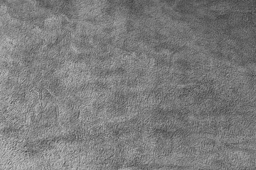 Texture of grey fluffy fleece blanket as abstract background.