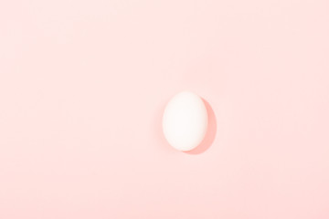 One egg on pink background