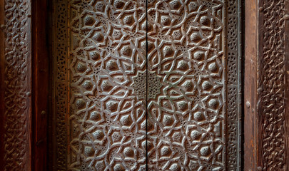 Bronze-plate door ornaments at the mosque of Sultan Hassan decorated with floral and geometric patterns, Cairo, Egypt