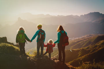 Obraz premium Mother with kids travel in mountains, family hiking in nature