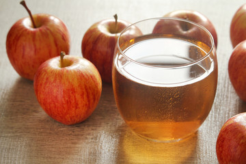 A glass with juice and apples