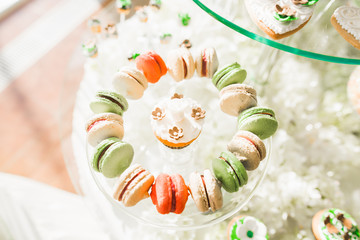 Delicious sweets on wedding candy buffet with desserts, cupcakes