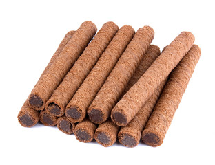 Waffle rolls with chocolate cream on white background