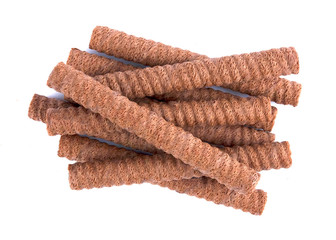 Waffle rolls with chocolate cream on white background