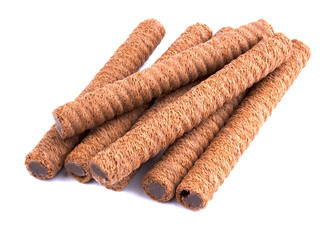 Waffle rolls with chocolate cream on white background