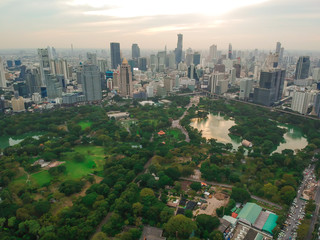 Aerial view city public park with modern building and fog