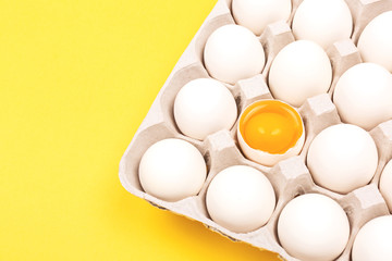 Eggs in egg box on yellow background