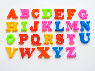  Magnetic Plastic ABC Letters Isolated. Colorful plastic English alphabet on a white  background. Learning english concept.kid is Learning the alphabets at home. 