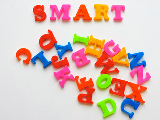  Magnetic Plastic ABC Letters Isolated. Colorful plastic English alphabet on a white  background. Learning english concept.kid is Learning the alphabets at home. 
