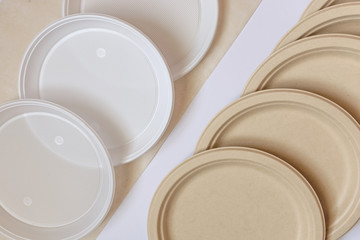 Heap of paper and plastic plate isolated on light background. Plastic free concept. Copy space