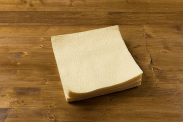 yellow paper napkin on wooden background
