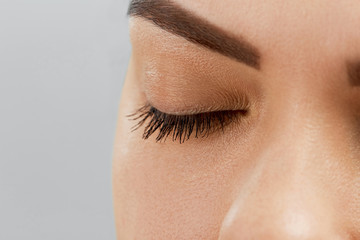Eyelash Care Treatment Procedures: Staining; Curling; Laminating and Extension for Lashes. Beauty Model with Perfect Fresh Skin and Long Eyelashes. Skincare; Spa and Wellness. Close up.